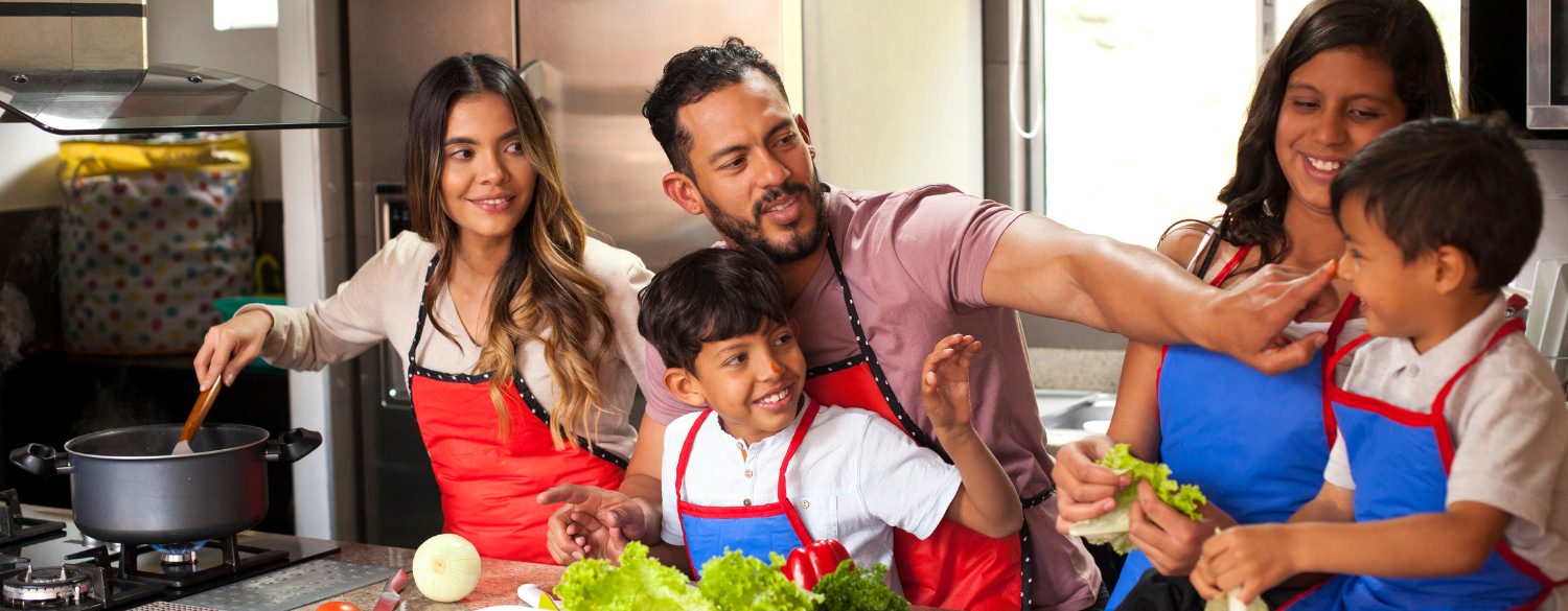 Family cooking in their kitchen and having fun