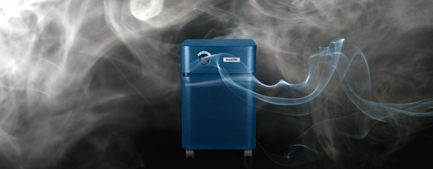 Blue air purifier surrounded by smoke