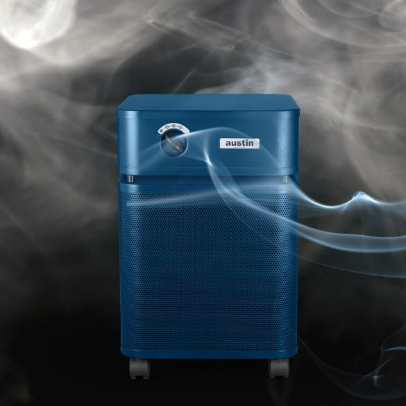 Blue air purifier surrounded by smoke