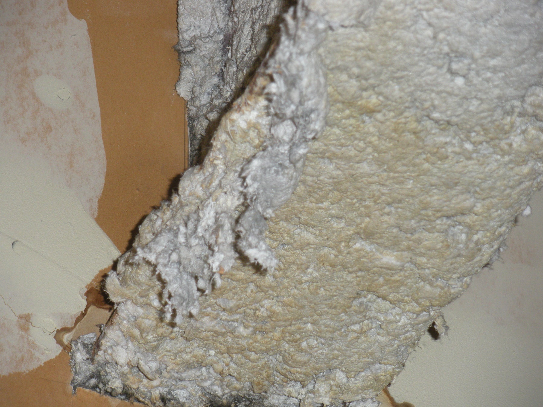 Exposed asbestos insulation material, highlighting the necessity for the best air purifier for asbestos to reduce airborne fibers.