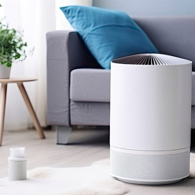 Cylindrical white air purifier in the living room in front of the couch picturing the topic: "Signs you need an air purifier"