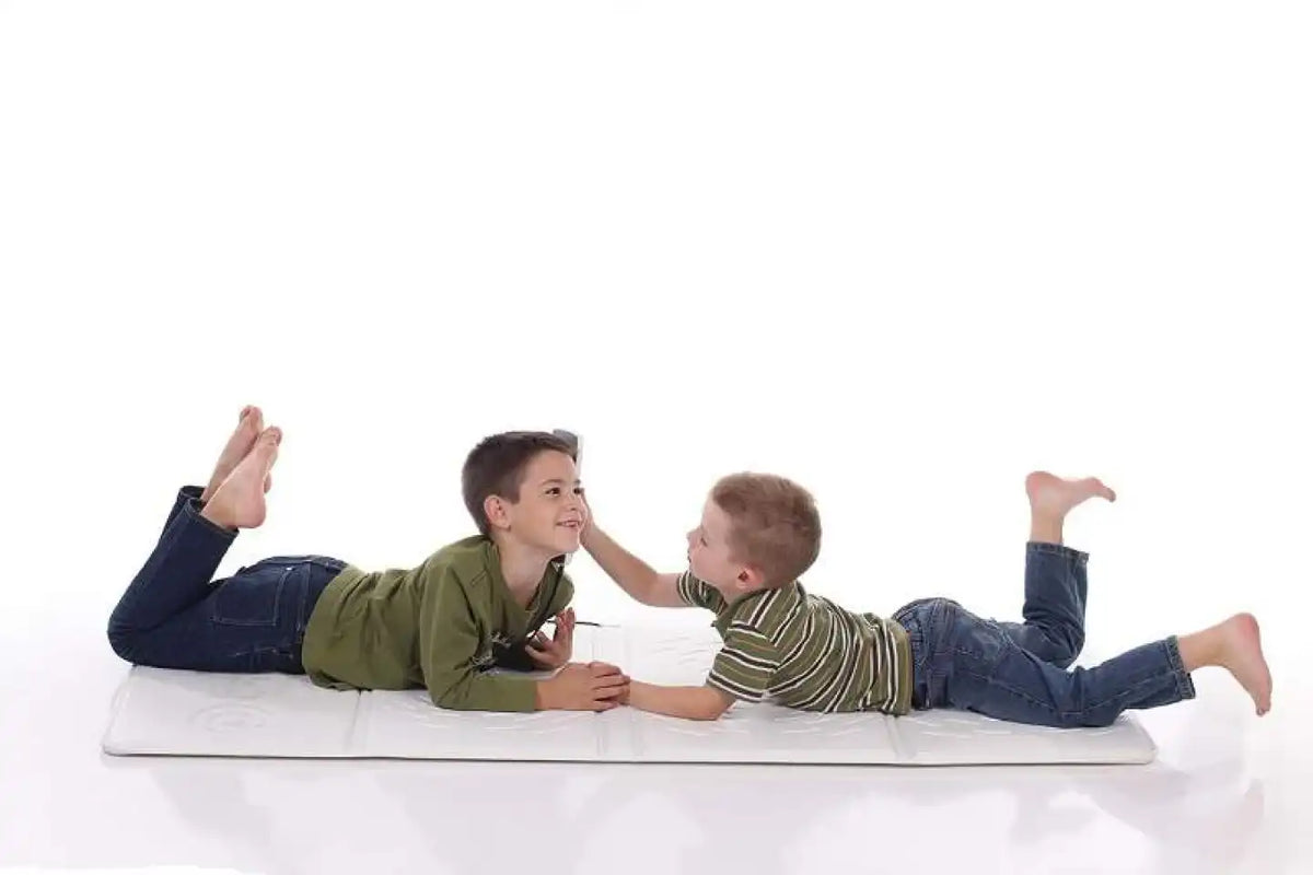 Kids enjoying using the Omi Pemf Therapy Mat