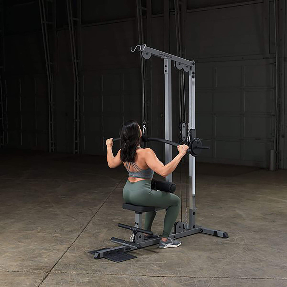 body solid lat machine glm83 woman lat pulldown
