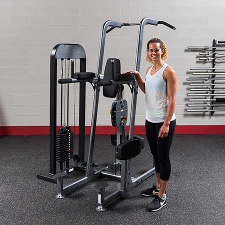 body solid pro select fcd stk chin dip machine woman beside machine