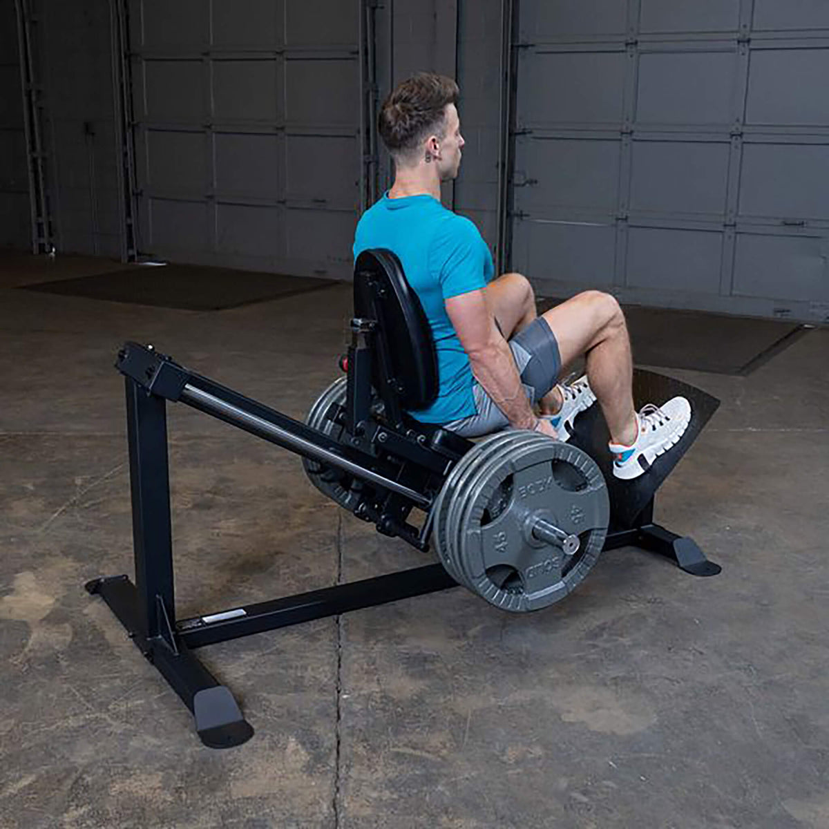 compact leg press machine gclp100 man back view