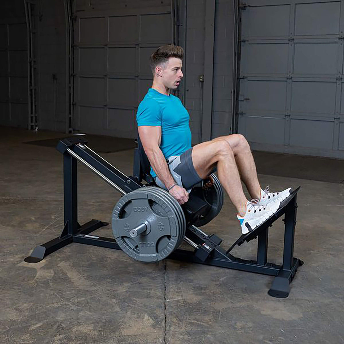 gclp100 compact leg press machine man side view