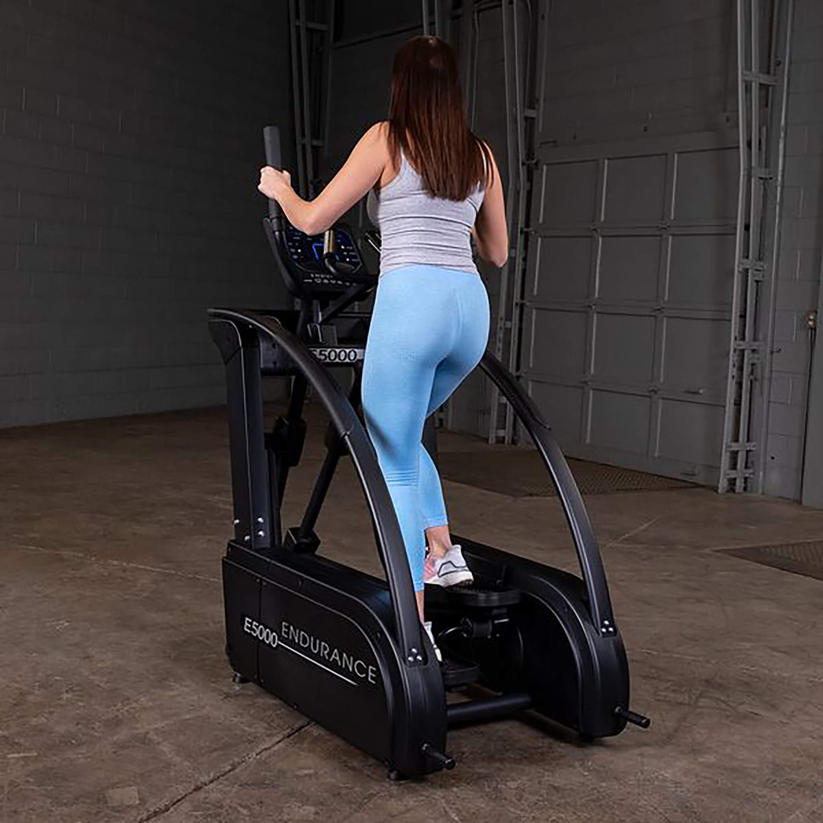 premium elliptical trainer e5000 woman exercise back side view